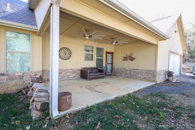 view of patio / terrace with a garage and ceiling fan