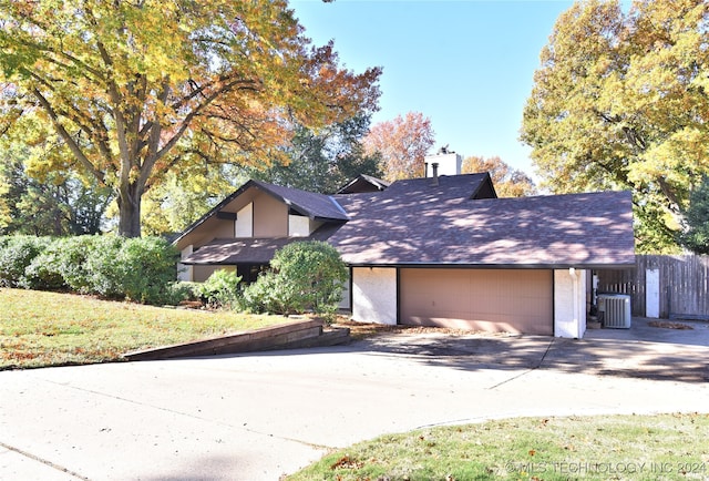 view of front of house featuring central air condition unit and a garage