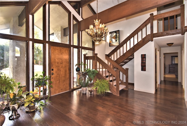 foyer entrance featuring wood-type flooring, high vaulted ceiling, and plenty of natural light