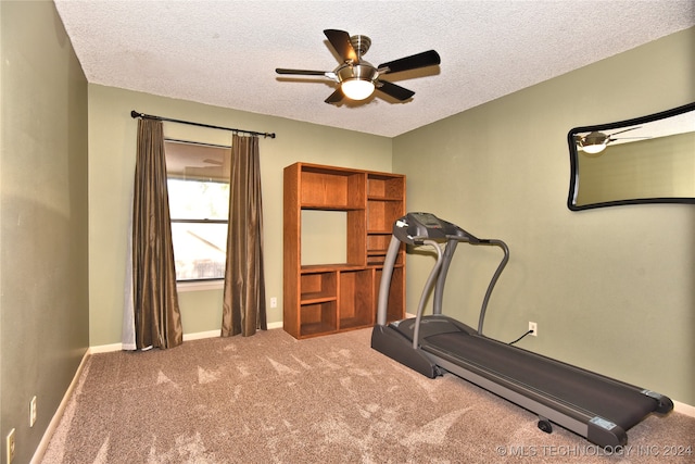 workout area with a textured ceiling, carpet floors, and ceiling fan