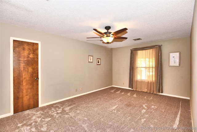 empty room featuring a textured ceiling, carpet floors, and ceiling fan