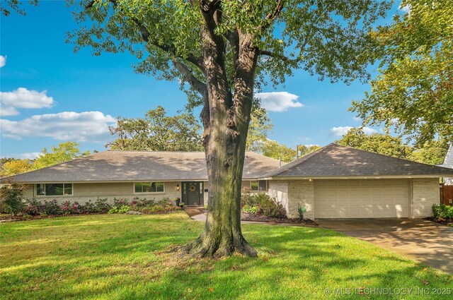 ranch-style house with a front lawn and a garage