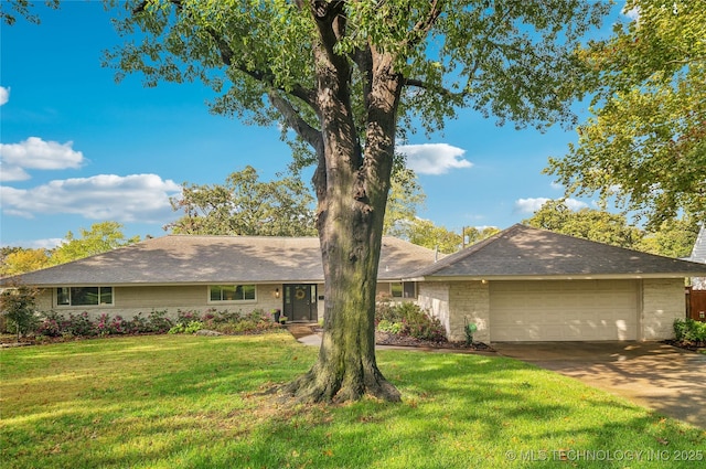 single story home with a front lawn, concrete driveway, and a garage