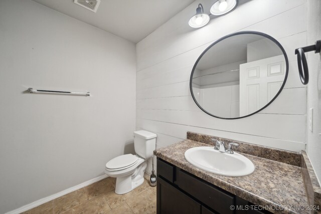 bathroom featuring toilet and vanity