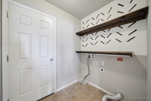 laundry area featuring washer hookup, electric dryer hookup, and light tile patterned floors