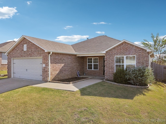 ranch-style home with a front lawn and a garage