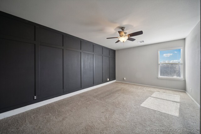 spare room with light carpet and ceiling fan