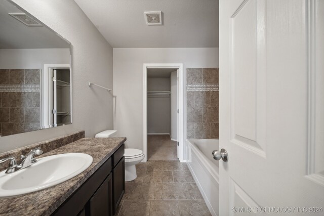 bathroom featuring tile patterned flooring, vanity, and toilet