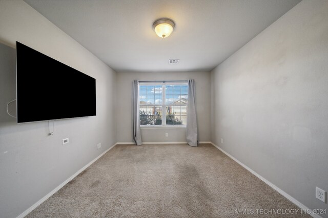 unfurnished room with light colored carpet