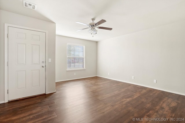 empty room featuring dark hardwood / wood-style flooring and ceiling fan