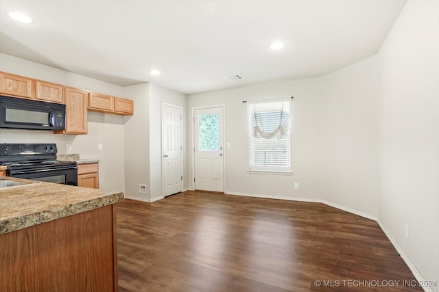 kitchen with dark wood-type flooring, light brown cabinetry, and black appliances