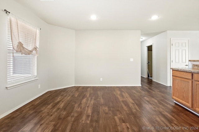 empty room featuring dark wood-type flooring