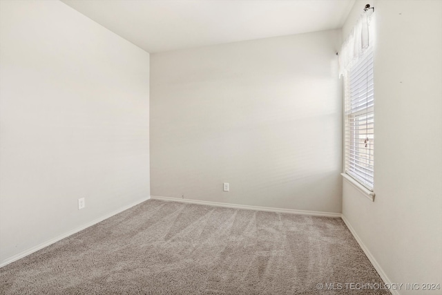 empty room with light colored carpet