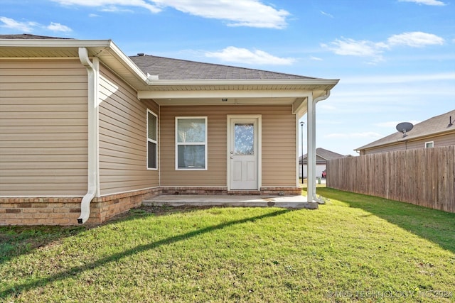 rear view of house featuring a yard