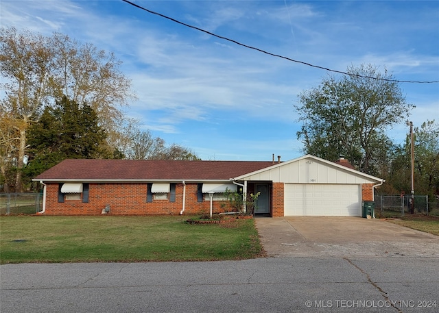 ranch-style house featuring a front lawn and a garage