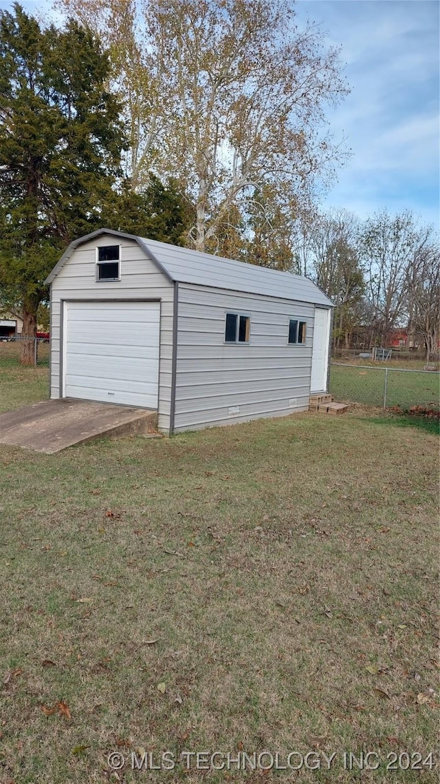 garage featuring a yard