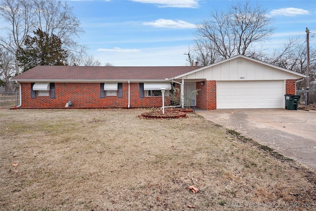 ranch-style home with a garage and a front lawn