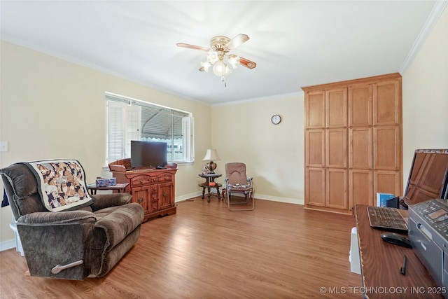 sitting room with ceiling fan, light wood-type flooring, and crown molding