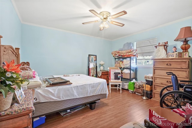 bedroom with ceiling fan, crown molding, and hardwood / wood-style flooring