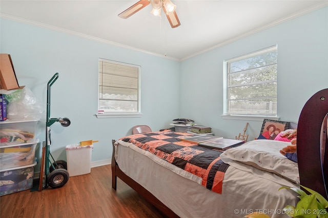 bedroom featuring ceiling fan, wood-type flooring, and ornamental molding