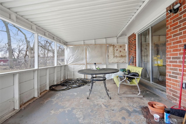 unfurnished sunroom featuring lofted ceiling