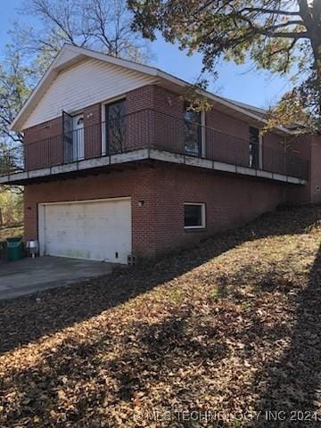 view of home's exterior with a balcony and a garage