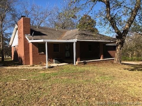 back of house with a yard