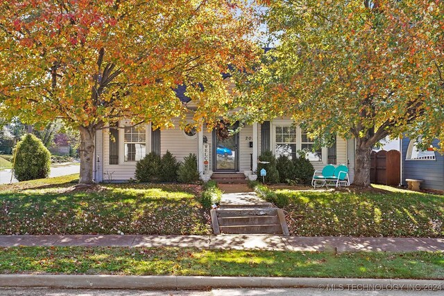 obstructed view of property with a front yard