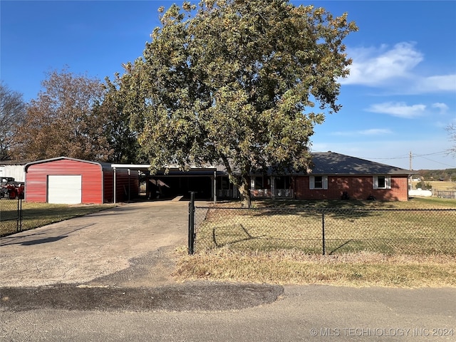 view of front of property with a garage, a carport, and a front lawn