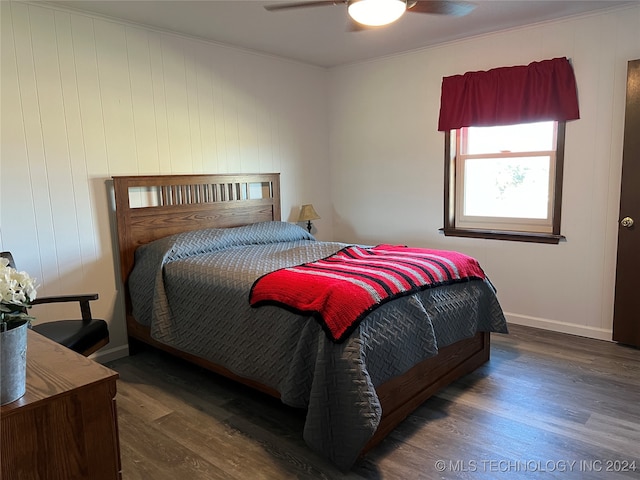 bedroom with ornamental molding, dark wood-type flooring, and ceiling fan