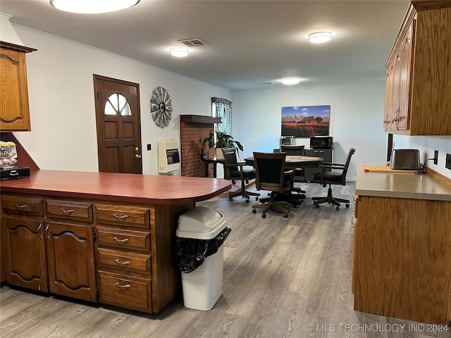 office area featuring light hardwood / wood-style flooring, crown molding, and heating unit