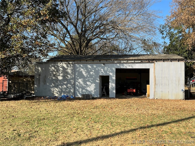 view of outbuilding featuring a lawn