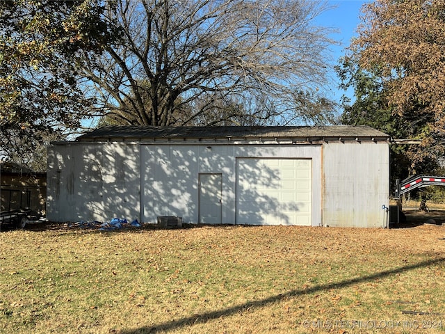 view of outbuilding with a garage and a yard