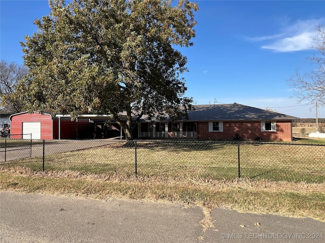 view of front of property with a carport and a front yard