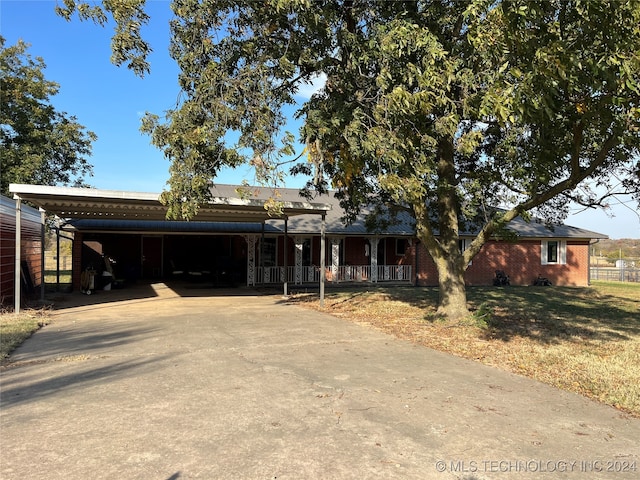 ranch-style house featuring a carport and a porch