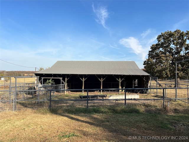 view of stable featuring a rural view