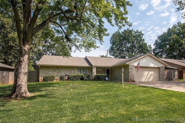 ranch-style house with a garage and a front yard