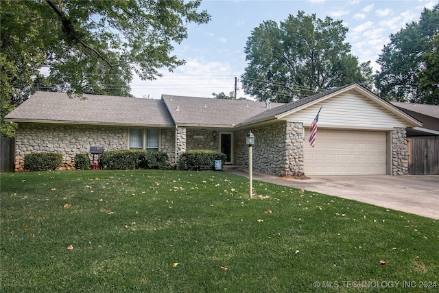 single story home featuring a garage and a front lawn