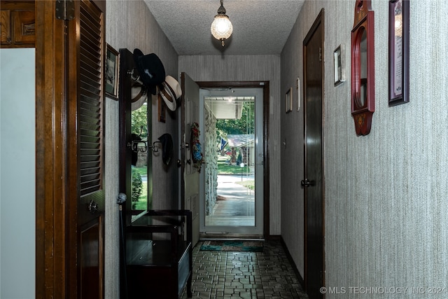 doorway with a textured ceiling