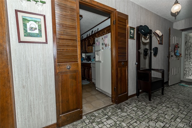 corridor with a textured ceiling