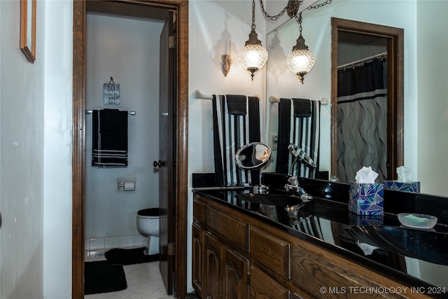 bathroom with vanity, tile patterned flooring, and toilet