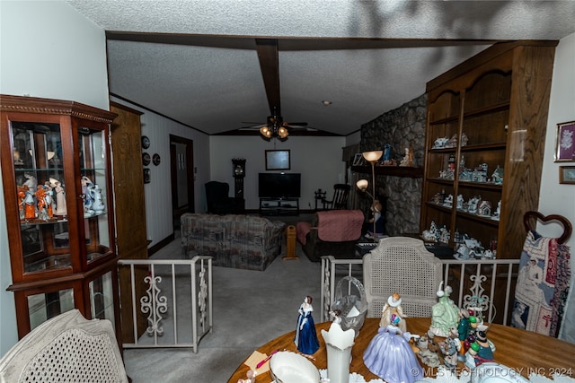 dining room featuring ceiling fan, carpet, a textured ceiling, and vaulted ceiling with beams