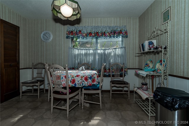 dining space with a textured ceiling