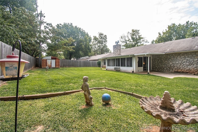 view of yard featuring a storage unit and a patio