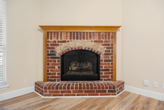 room details with hardwood / wood-style flooring and a fireplace