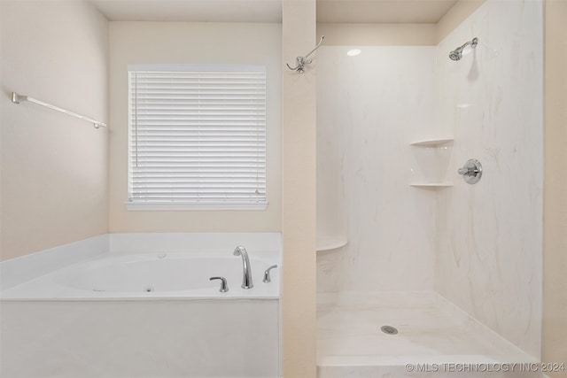 bathroom featuring shower with separate bathtub