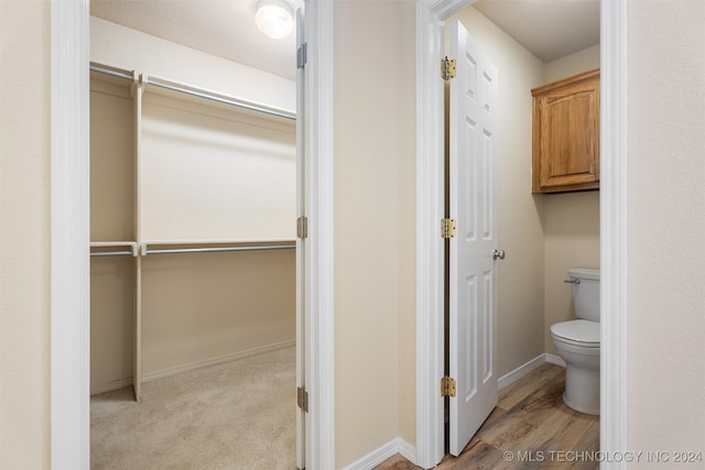 bathroom featuring hardwood / wood-style floors and toilet