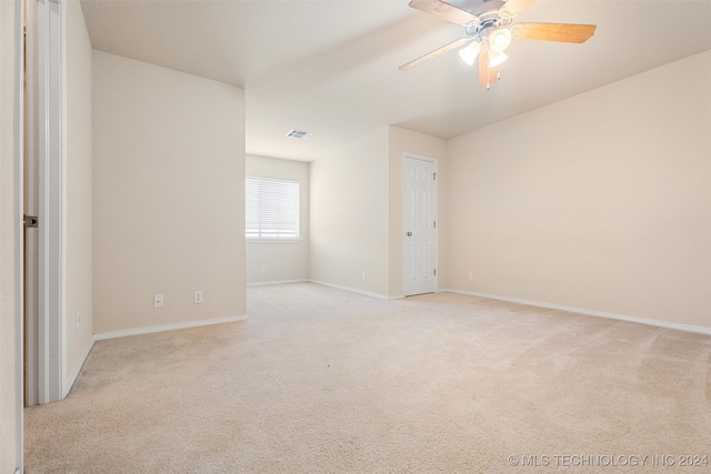 carpeted empty room featuring ceiling fan