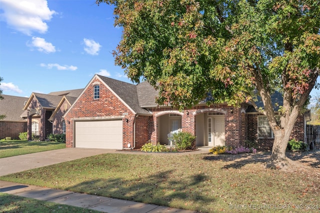 view of front facade with a front yard and a garage