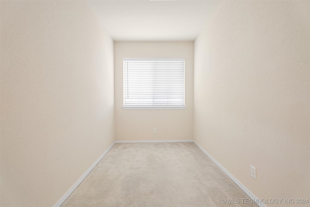 spare room with light colored carpet